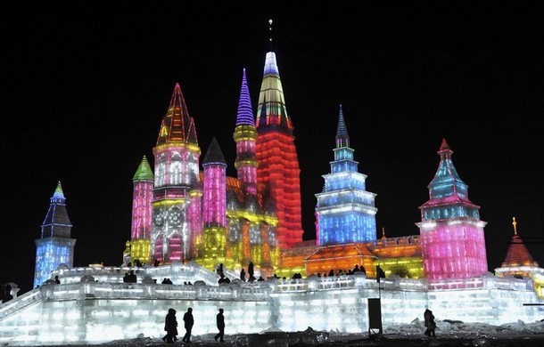 People visit ice sculptures for the upcoming 25th Harbin International Ice and Snow Festival at a park in Harbin